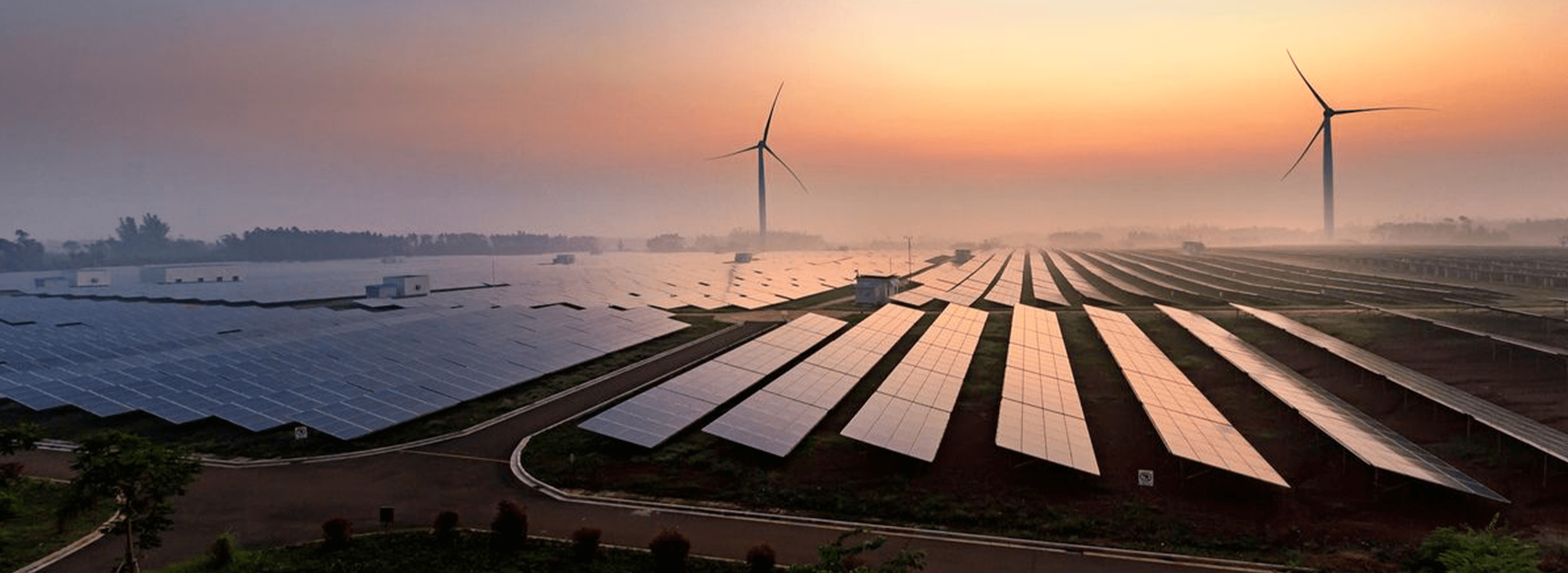 Solar farm and wind turbines at sunrise in Kutch